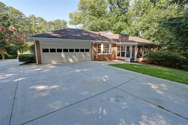 ranch-style home featuring a front yard and a garage