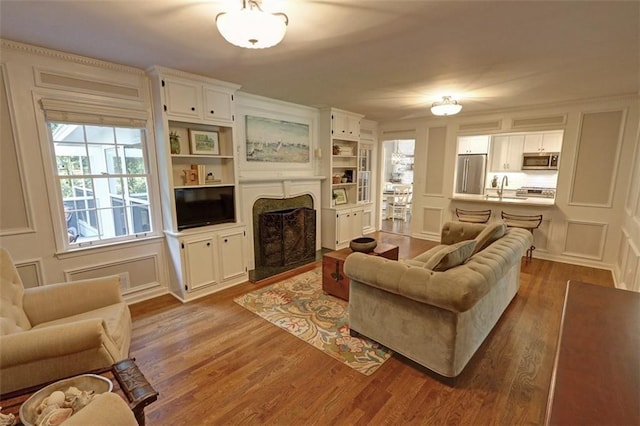 living room featuring sink and dark wood-type flooring