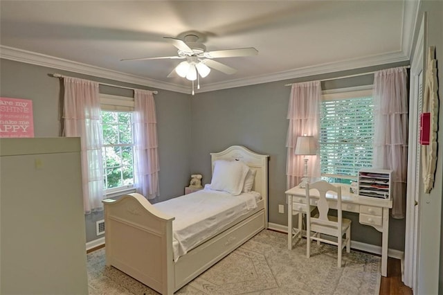 bedroom with ornamental molding and ceiling fan