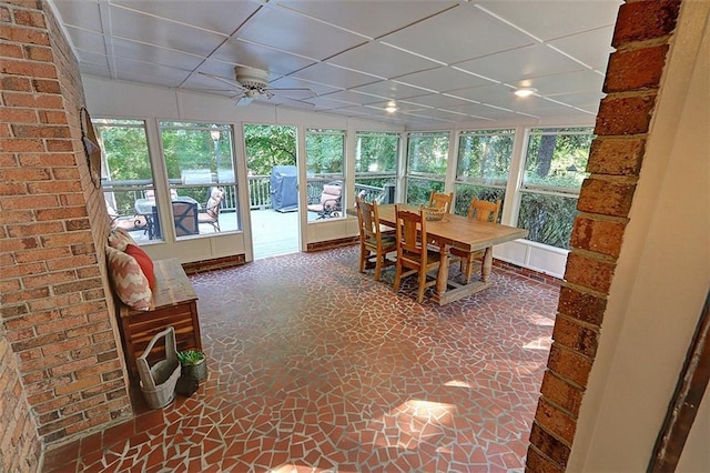 sunroom / solarium featuring ceiling fan and a paneled ceiling