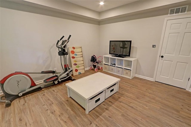 workout area featuring light wood-type flooring