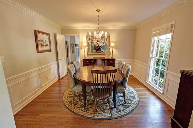 dining area with a notable chandelier, crown molding, and dark hardwood / wood-style floors