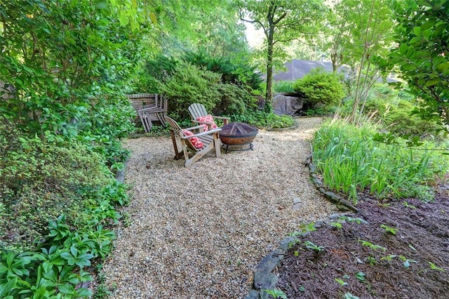 view of yard with an outdoor fire pit