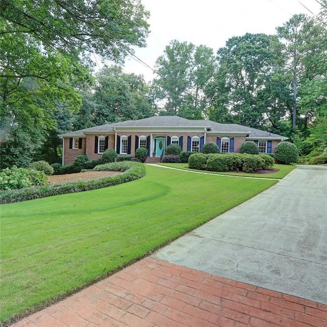 ranch-style home with a front lawn