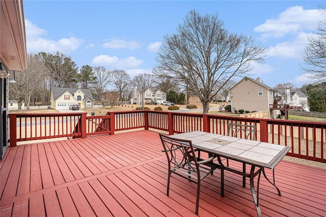 deck featuring a residential view and outdoor dining area