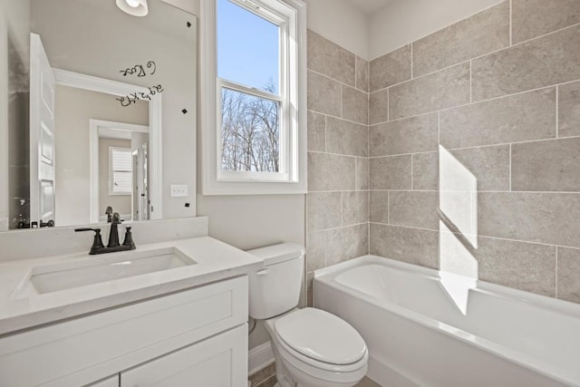 bathroom with toilet, plenty of natural light, vanity, and tub / shower combination