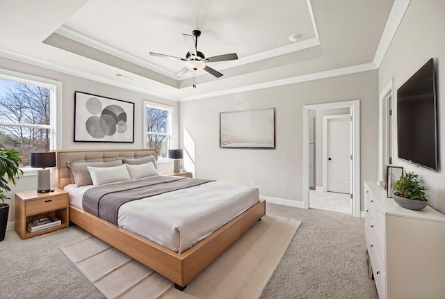 bedroom with light carpet, visible vents, crown molding, and a tray ceiling