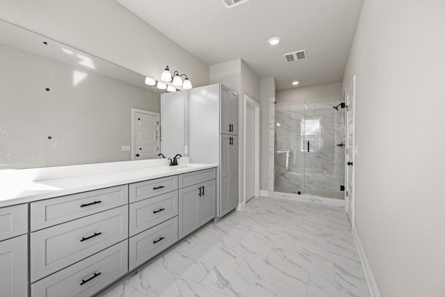 bathroom with a marble finish shower, visible vents, baseboards, marble finish floor, and a sink