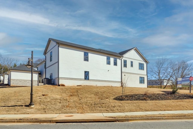 view of front of house with central AC and an outdoor structure