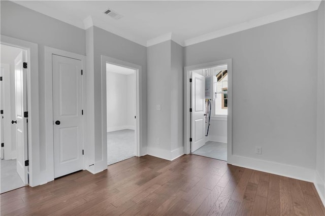 spare room with hardwood / wood-style flooring and ornamental molding