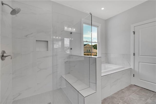 bathroom featuring tile patterned flooring and shower with separate bathtub