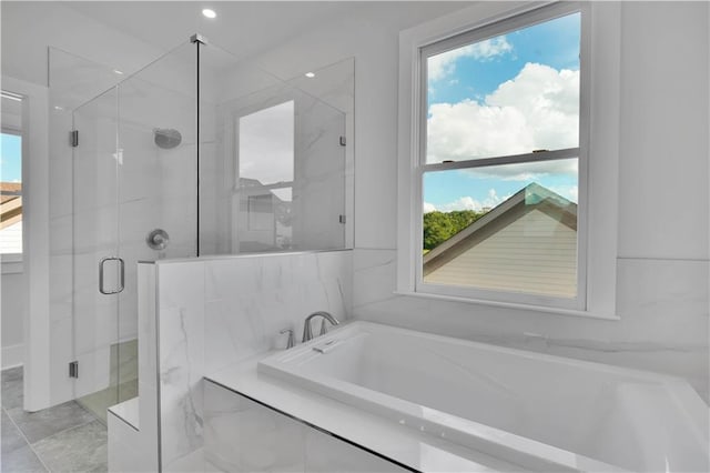 bathroom featuring independent shower and bath