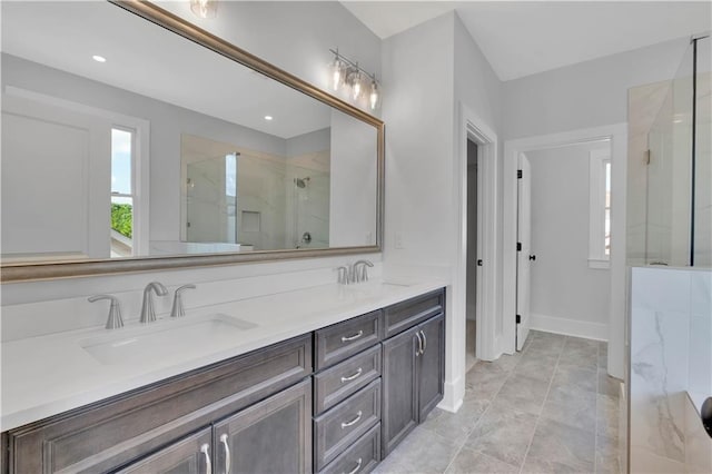bathroom featuring a shower with shower door and vanity