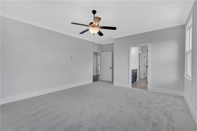 unfurnished bedroom featuring ceiling fan, connected bathroom, ornamental molding, and light carpet