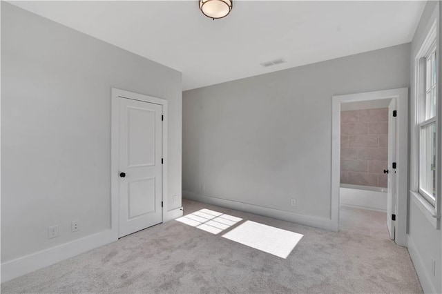 spare room with light carpet and a healthy amount of sunlight