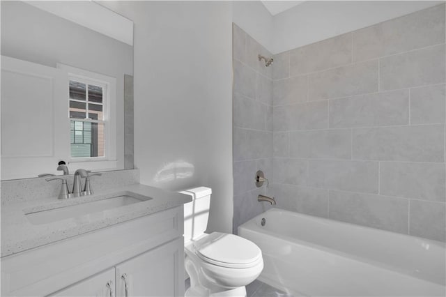 full bathroom featuring toilet, vanity, and tiled shower / bath