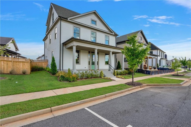view of front of house with covered porch and a front yard