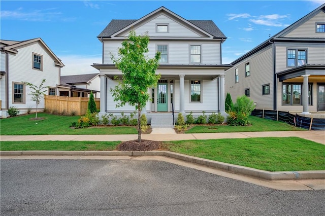 view of front of property featuring covered porch and a front yard
