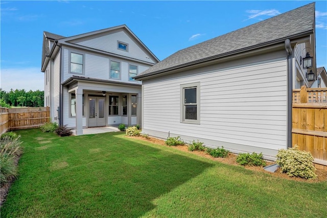 back of house with a patio area and a yard