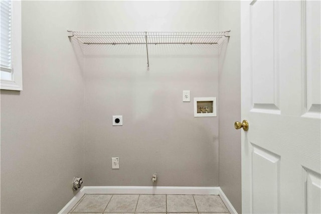 washroom featuring electric dryer hookup, light tile patterned flooring, and washer hookup