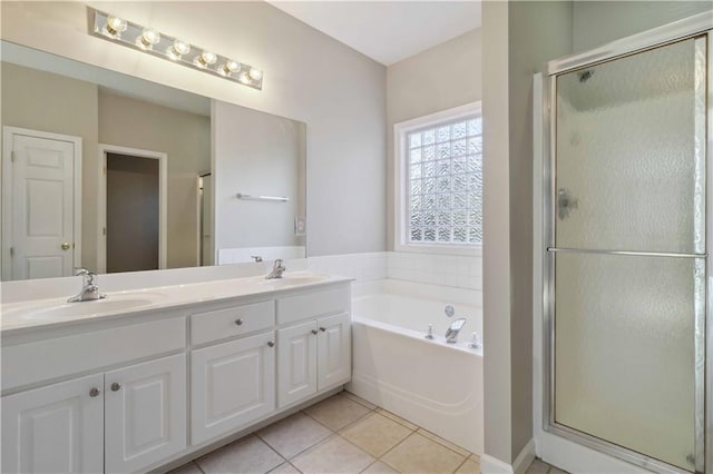 bathroom with tile patterned floors, separate shower and tub, and vanity