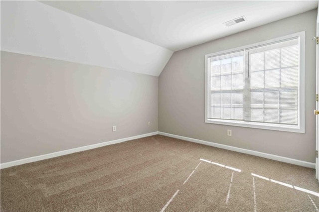 bonus room with carpet flooring and lofted ceiling