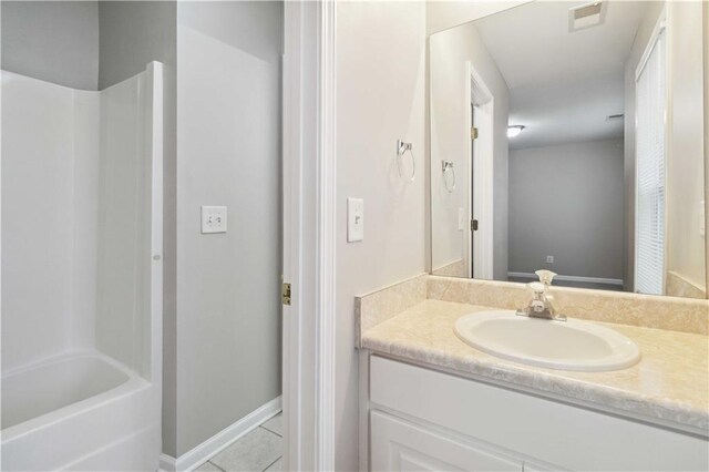 bathroom with tile patterned floors, vanity, and shower / bathing tub combination