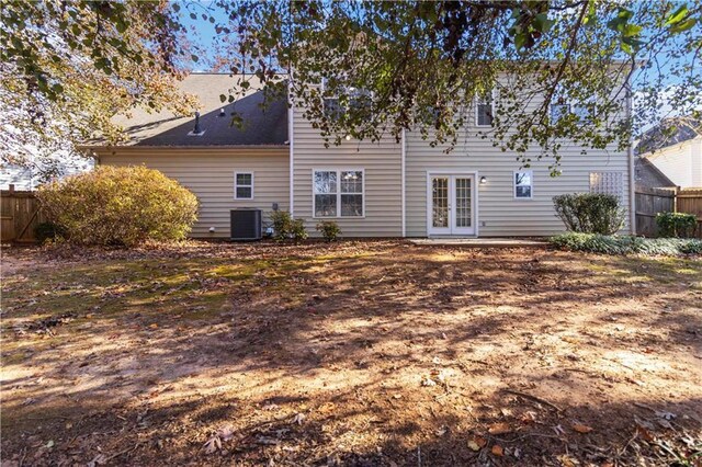 rear view of house with cooling unit and french doors