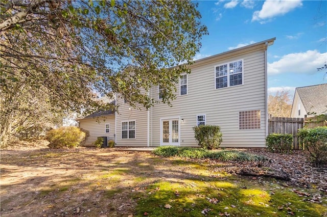 rear view of house with central AC and french doors