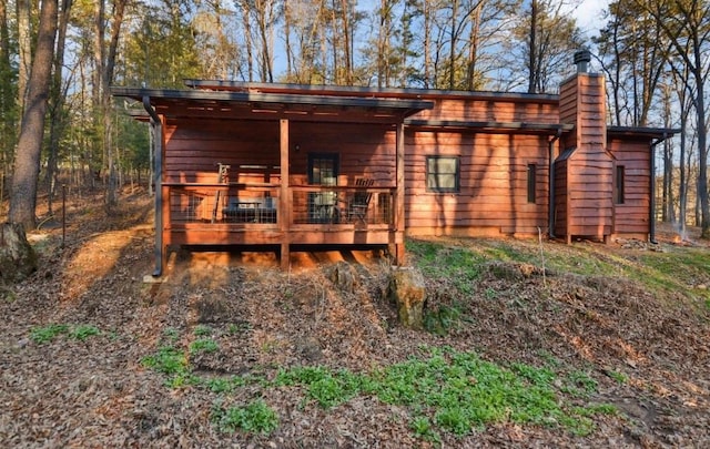 rear view of house with a wooden deck