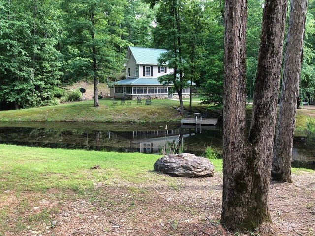 rear view of house featuring a water view