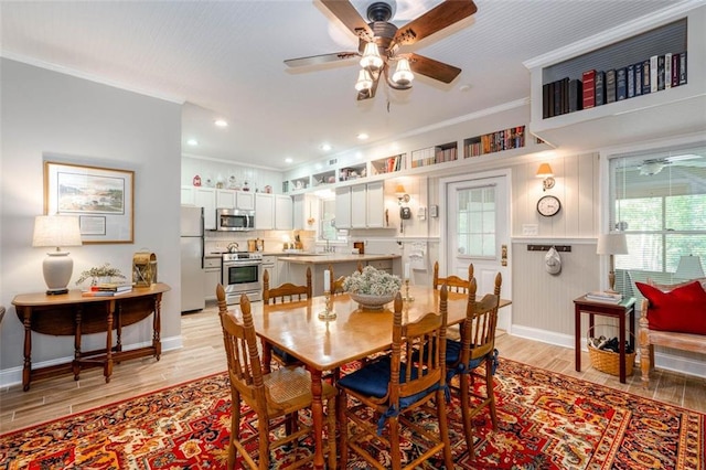 dining space featuring ceiling fan, light hardwood / wood-style flooring, and ornamental molding