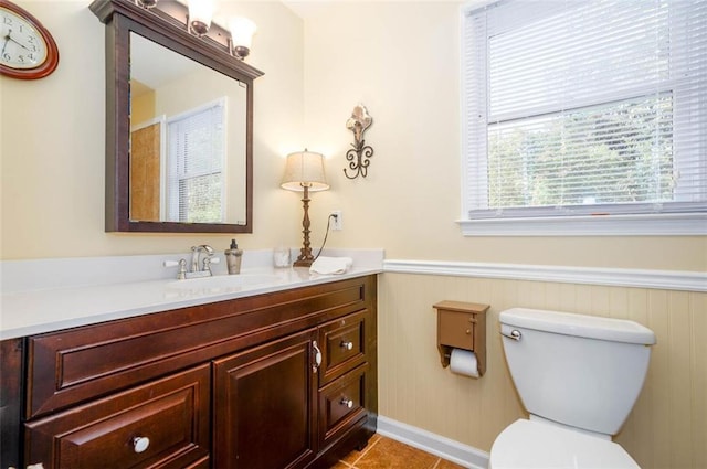 bathroom with tile patterned flooring, vanity, and toilet