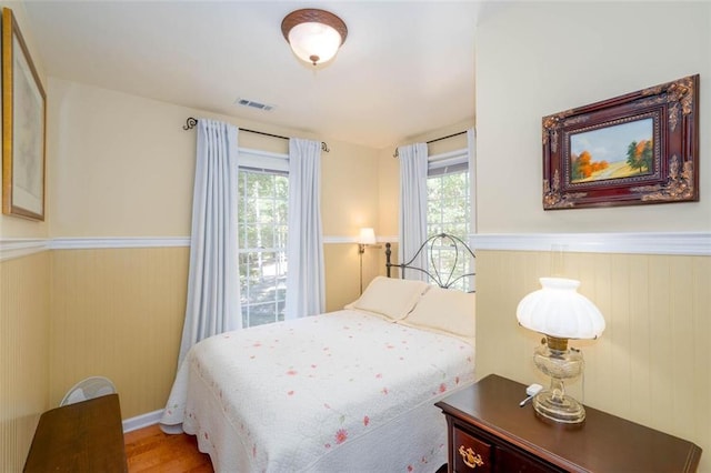 bedroom featuring multiple windows and wood-type flooring