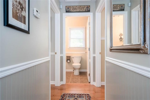 bathroom featuring wood-type flooring and toilet