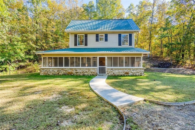 country-style home with a sunroom and a front lawn