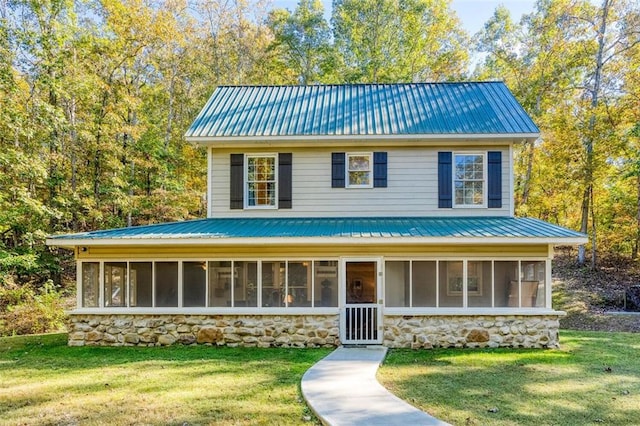 view of front of property with a sunroom and a front lawn