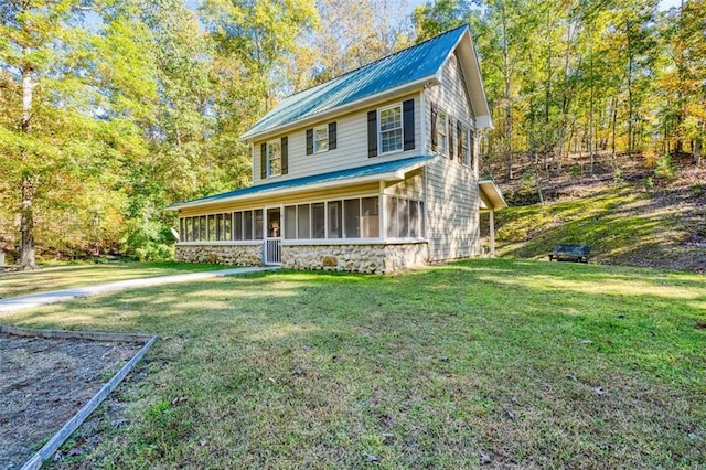 view of front of property featuring a sunroom and a front yard