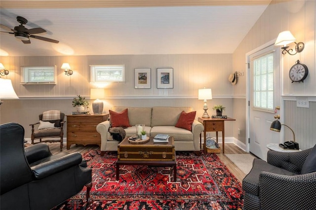 living room with lofted ceiling, hardwood / wood-style floors, and ceiling fan