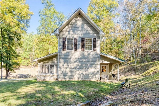 view of property with a sunroom and a front yard