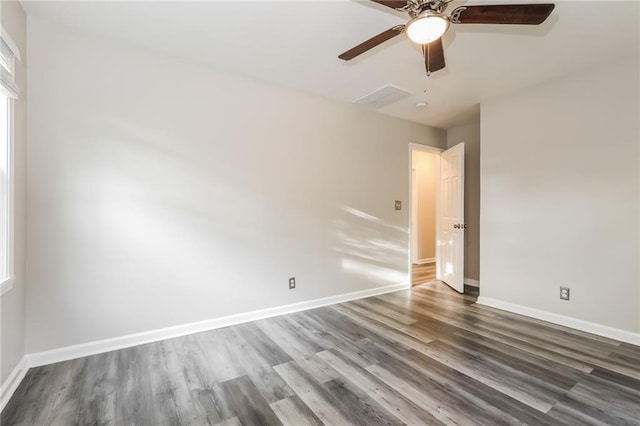 spare room with baseboards, a ceiling fan, and wood finished floors