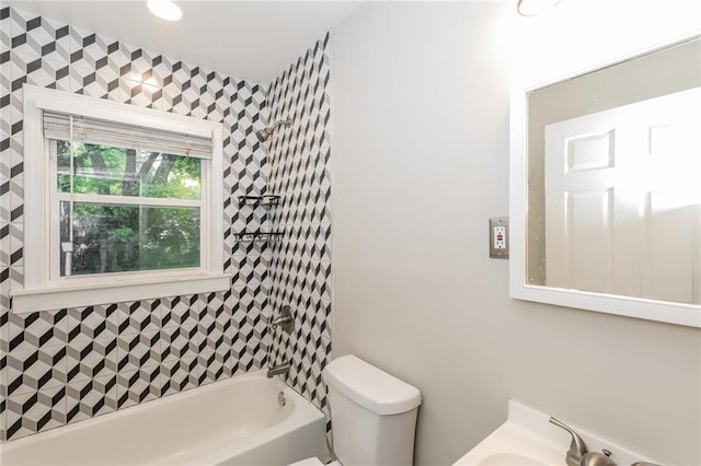 bathroom featuring a sink, shower / bathtub combination, and toilet