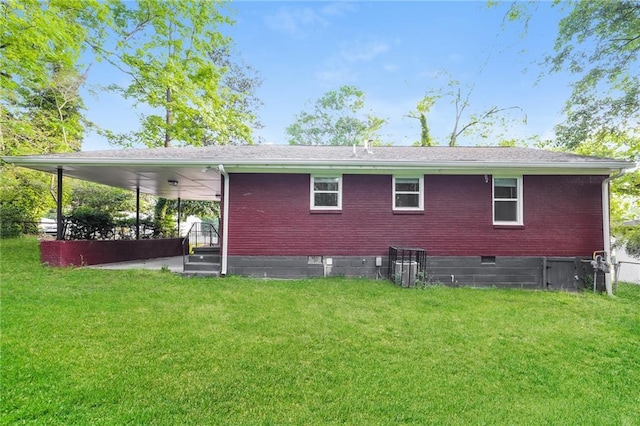 rear view of property with a lawn, brick siding, and crawl space