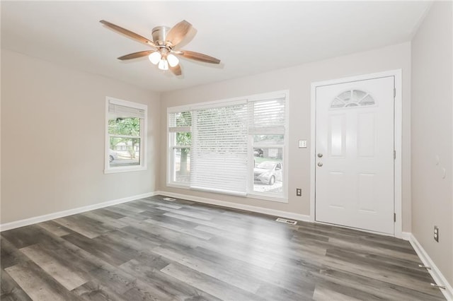 entryway featuring baseboards, a ceiling fan, wood finished floors, and visible vents