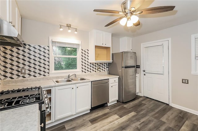 kitchen with ceiling fan, appliances with stainless steel finishes, a sink, light countertops, and under cabinet range hood