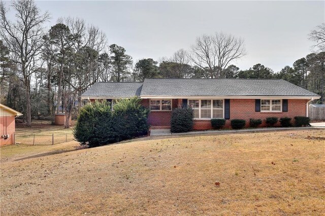 ranch-style house with a front lawn