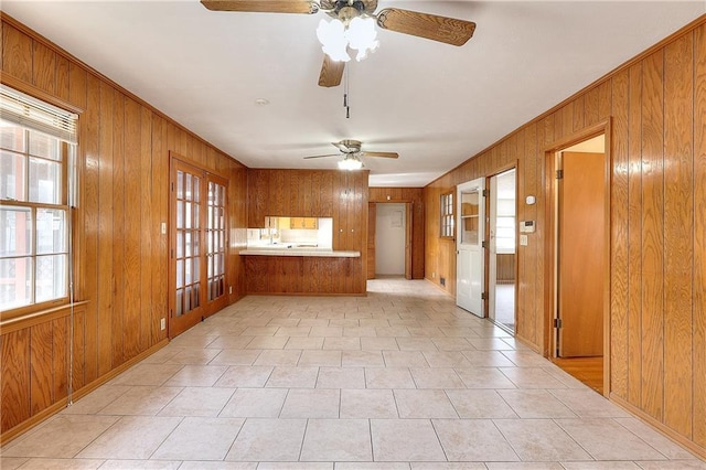 kitchen featuring kitchen peninsula and wood walls