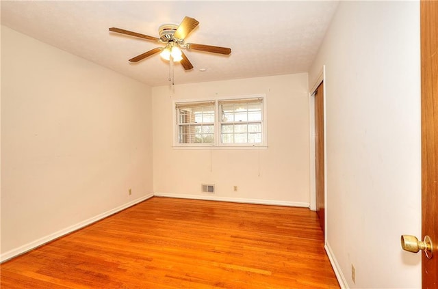 empty room with ceiling fan and light wood-type flooring