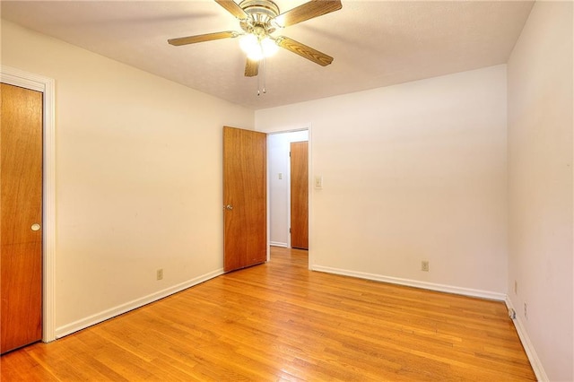 empty room with light hardwood / wood-style floors and ceiling fan