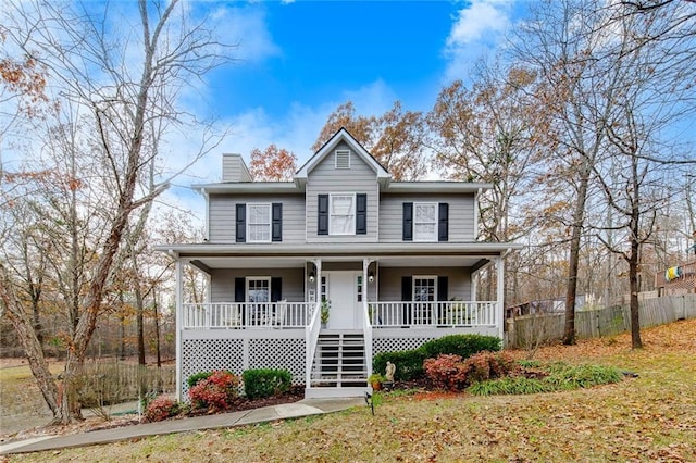 view of front of property featuring covered porch and a front yard